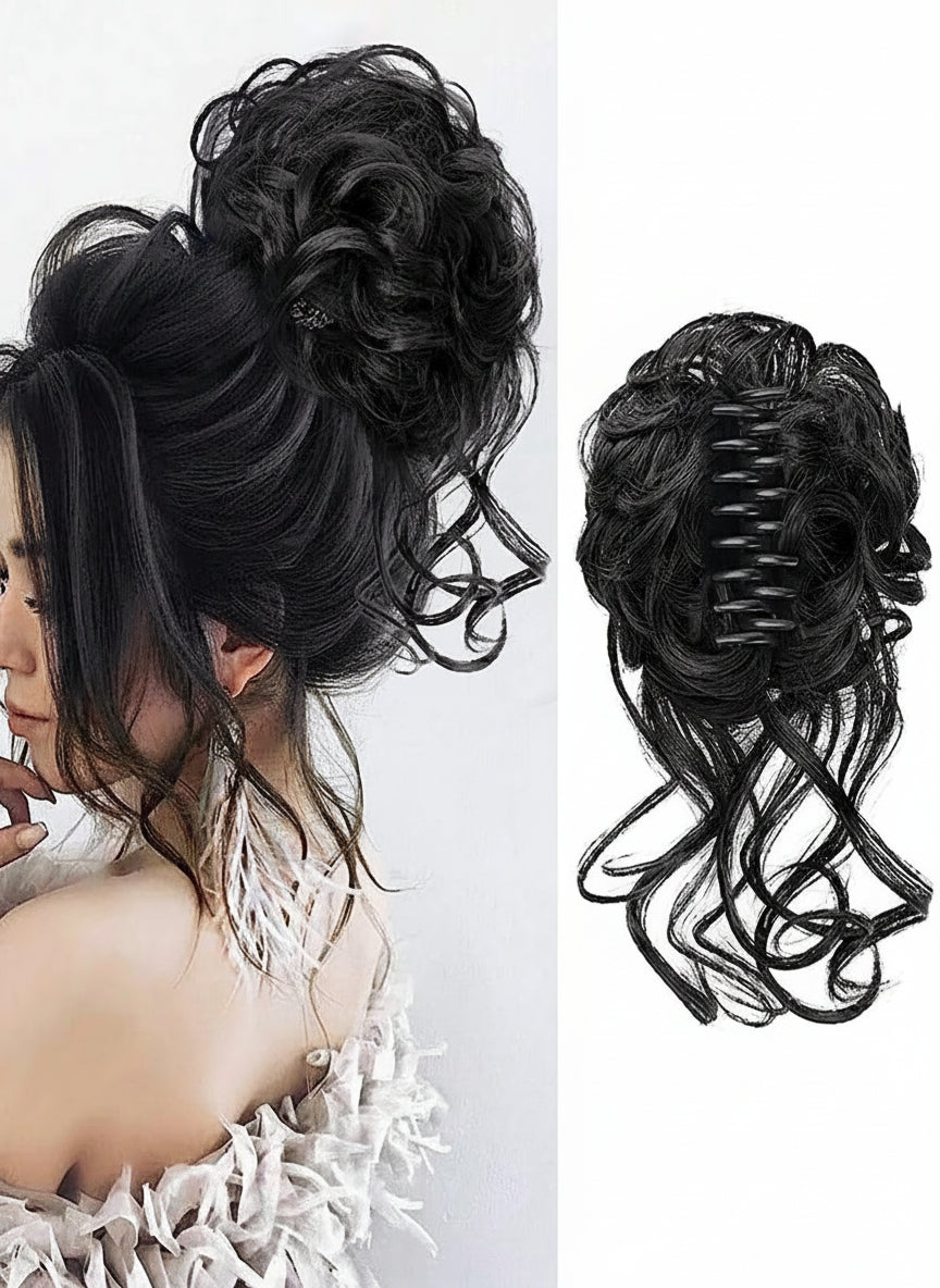 Black hairpiece styled in an updo with a plain background