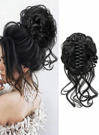 Black hairpiece styled in an updo with a plain background