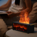 Small electric fireplace with flames on a table, person reading a book in the background