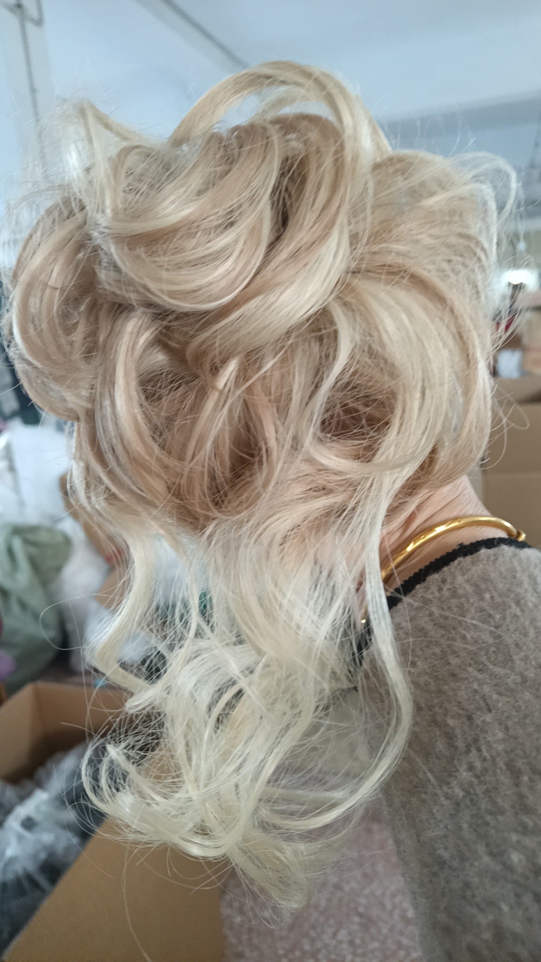 Blonde hair extension on a person with a blurred background