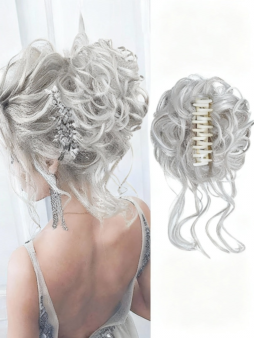 Blonde hairpiece styled in an updo with a decorative clip, on a white background.