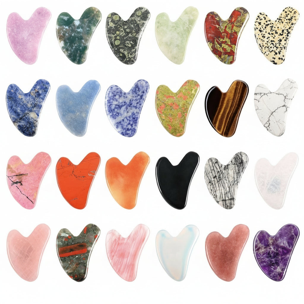 Collection of various stone gua sha tools with different colors and patterns on a white background.